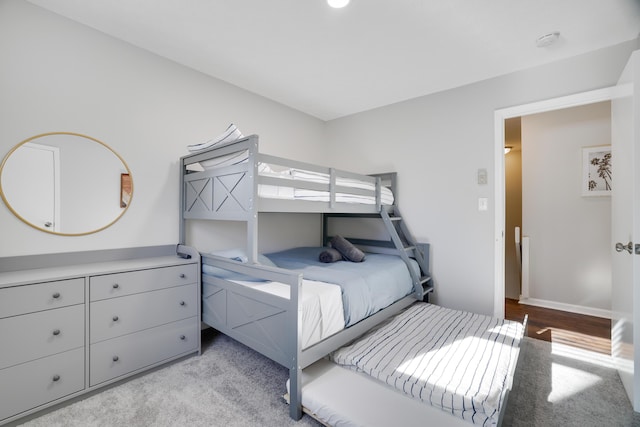 bedroom with baseboards and light carpet