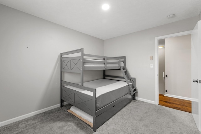 bedroom with baseboards and carpet floors