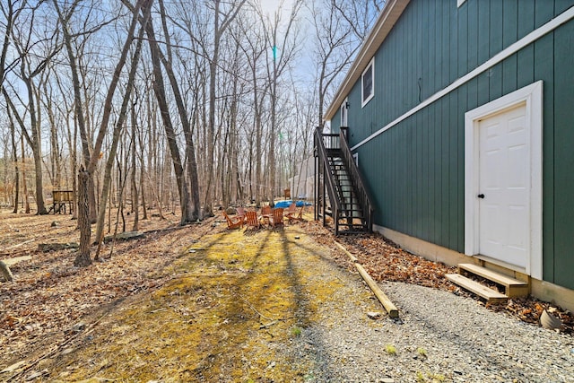 view of yard with stairway and entry steps