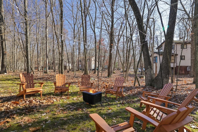 view of yard with an outdoor fire pit