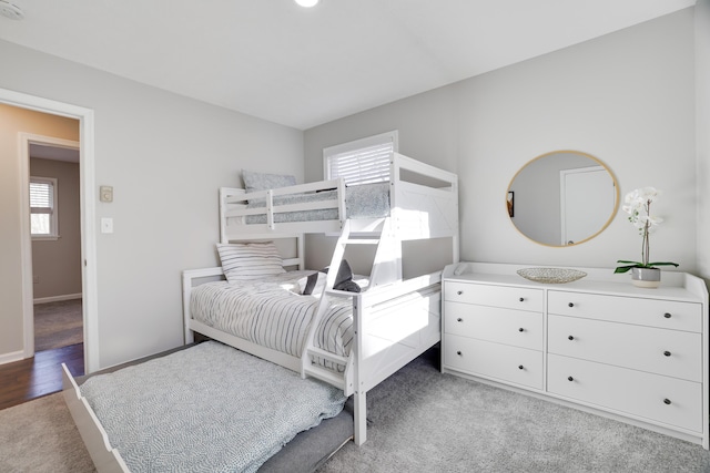 carpeted bedroom featuring baseboards