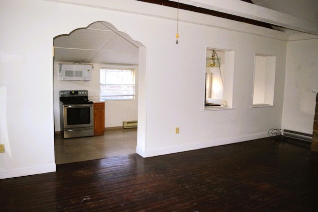 spare room featuring hardwood / wood-style floors, baseboards, and a baseboard radiator