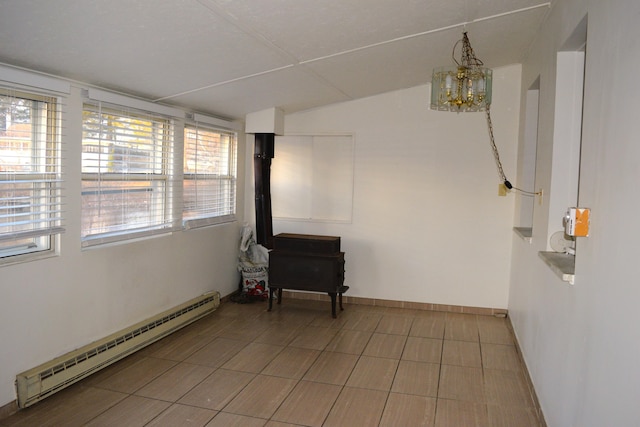 empty room featuring baseboards, a chandelier, and a baseboard radiator