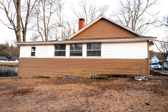 view of side of property with a chimney