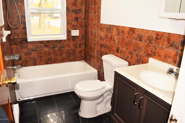 bathroom with tile patterned floors, toilet, tile walls, and vanity