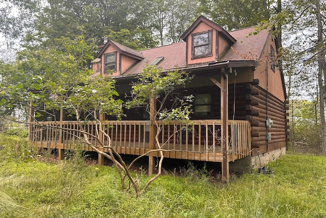 9416 Juniper Dr, Tobyhanna, PA 18466 - back of property with a wooden deck, log exterior, and a shingled roof