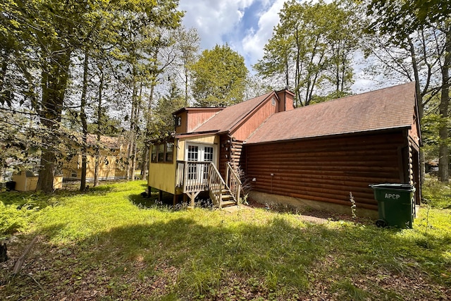 9416 Juniper Dr, Tobyhanna, PA 18466 - rear view of property featuring log siding, a chimney, a shingled roof, and a wooden deck