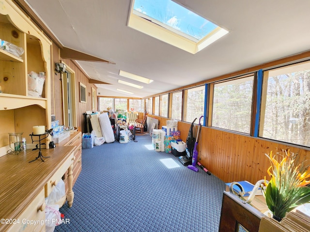 sunroom featuring lofted ceiling with skylight