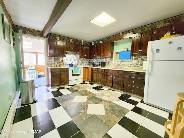 kitchen featuring white appliances, light countertops, and light floors