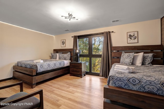 bedroom with visible vents and wood finished floors