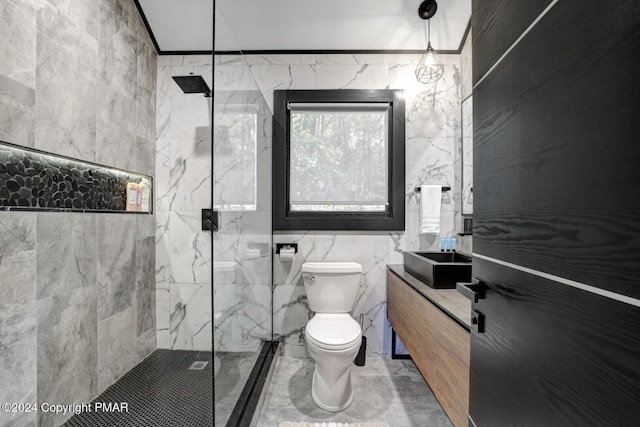 full bath featuring toilet, a marble finish shower, tile walls, and vanity