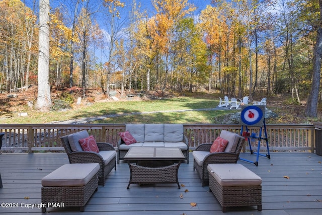 wooden deck with an outdoor living space and a yard