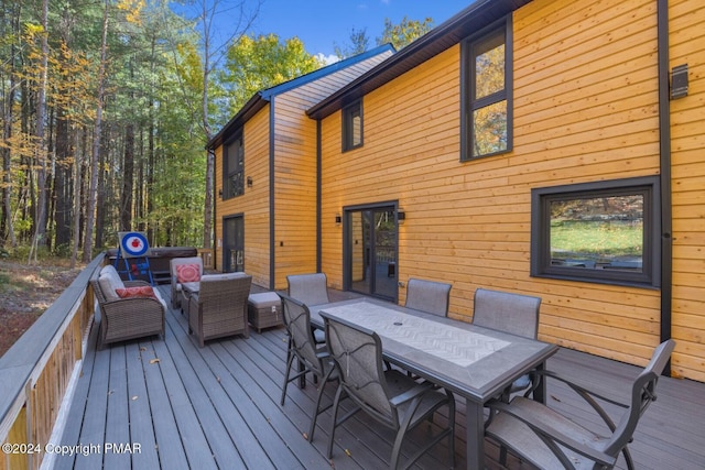 deck featuring outdoor lounge area and outdoor dining area