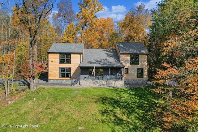 view of front of home featuring covered porch and a front yard