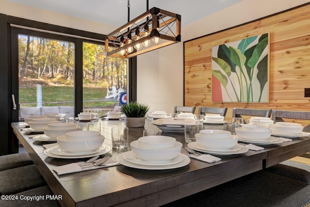 dining room featuring plenty of natural light and wooden walls