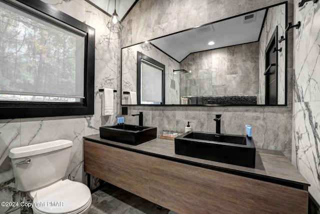 full bathroom featuring toilet, double vanity, visible vents, and a sink