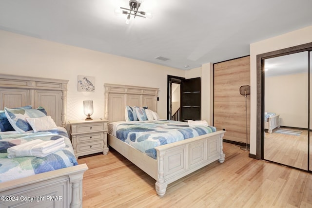 bedroom with light wood-type flooring and visible vents