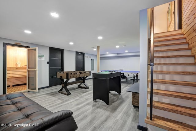 game room with recessed lighting and light wood finished floors