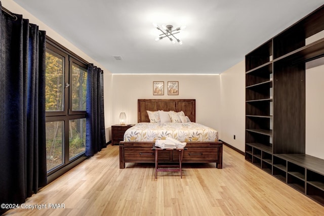 bedroom featuring baseboards, visible vents, and light wood-style floors