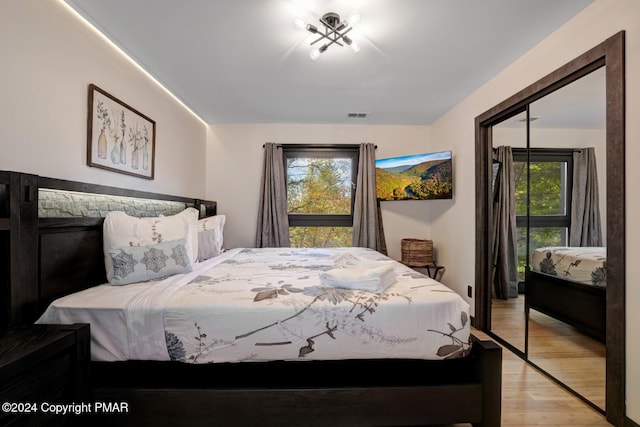 bedroom featuring light wood-style flooring and visible vents