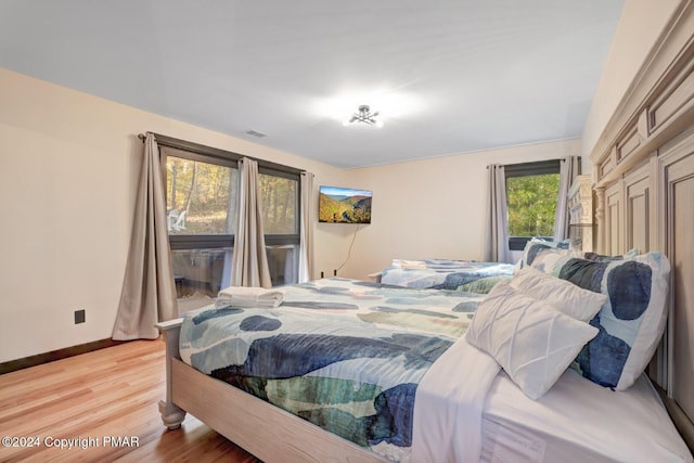 bedroom featuring light wood-type flooring and baseboards