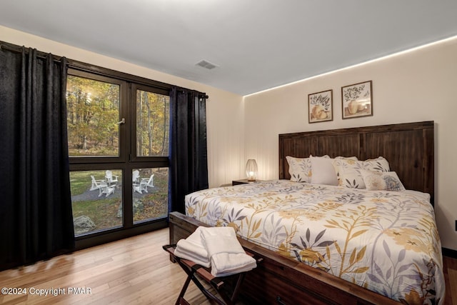 bedroom with visible vents and light wood-style flooring