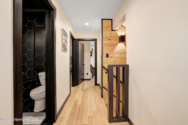 hall with baseboards, recessed lighting, and light wood-style floors