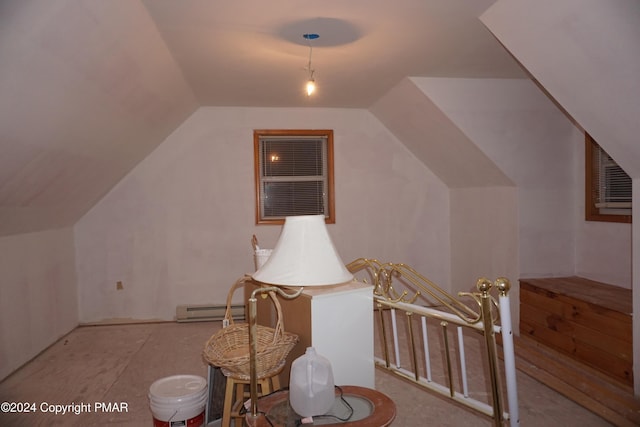 additional living space featuring lofted ceiling and a baseboard radiator