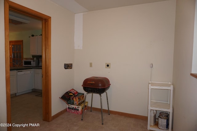 washroom featuring laundry area, hookup for a washing machine, electric dryer hookup, and baseboards