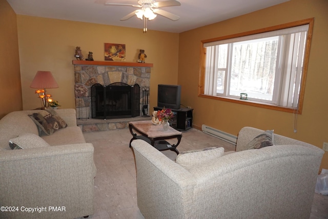 living room with a ceiling fan, a baseboard radiator, and a stone fireplace