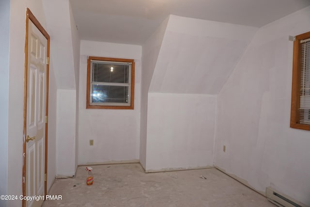 additional living space featuring lofted ceiling and baseboard heating