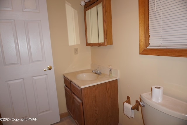 half bathroom featuring toilet and vanity