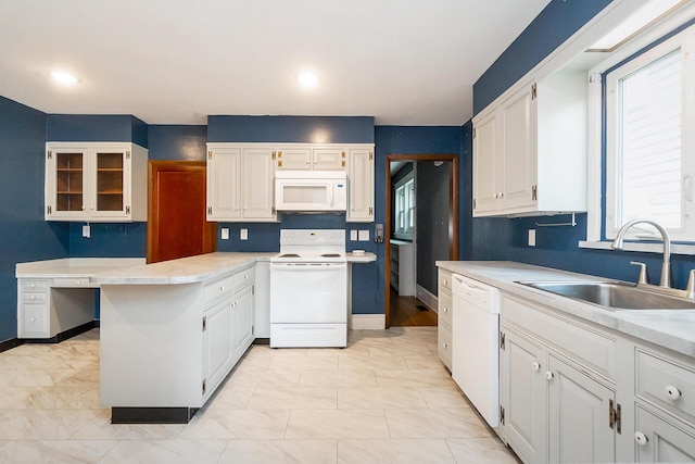 312 Columbia Ave, Palmerton, PA 18071 - kitchen with white appliances, white cabinets, a peninsula, and light countertops