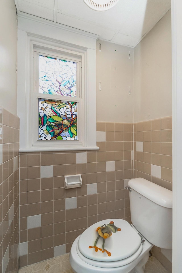 312 Columbia Ave, Palmerton, PA 18071 - bathroom with tile walls, a wainscoted wall, and tile patterned floors