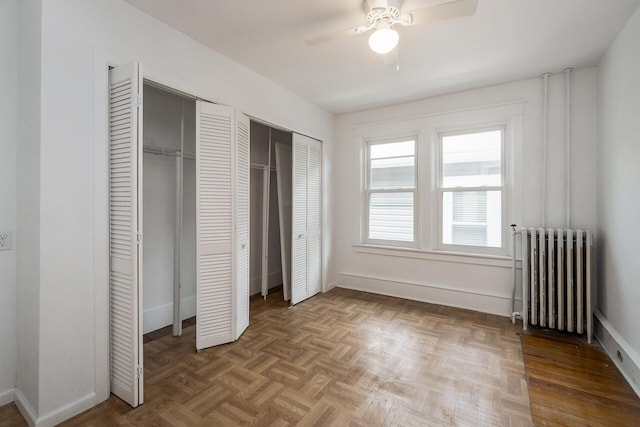 312 Columbia Ave, Palmerton, PA 18071 - unfurnished bedroom with radiator, two closets, and a ceiling fan