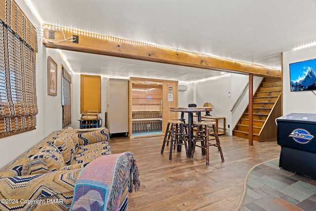 dining space featuring wood finished floors and stairs