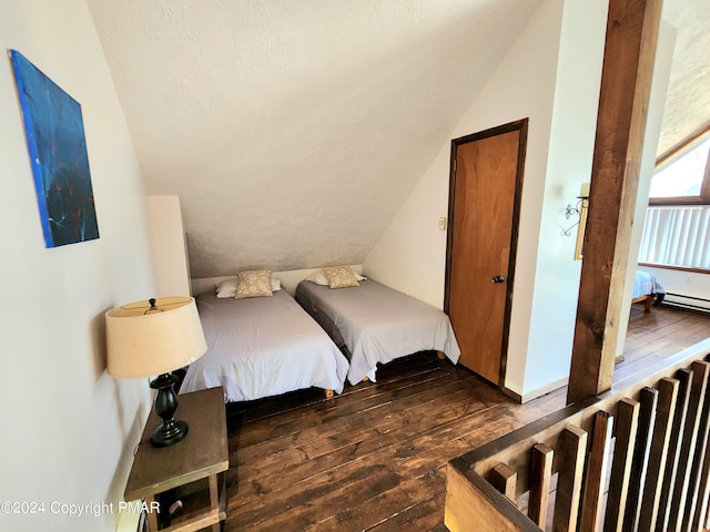 bedroom featuring lofted ceiling, dark hardwood / wood-style flooring, and a textured ceiling