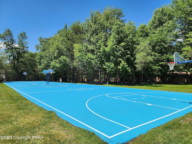 view of sport court with a yard