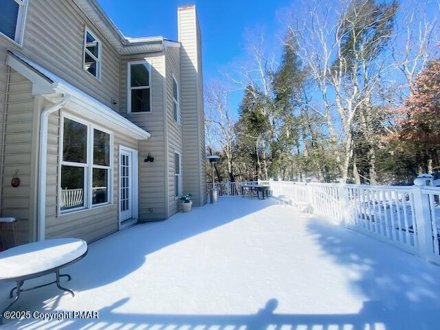 yard layered in snow featuring a patio area