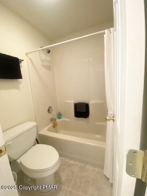 bathroom with toilet and shower / bath combo