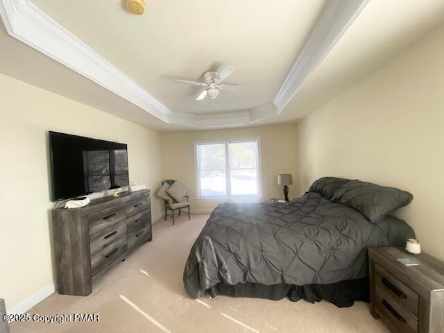 bedroom featuring ceiling fan, light colored carpet, crown molding, and a raised ceiling