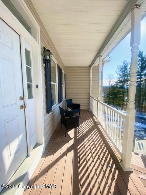 wooden terrace featuring a porch