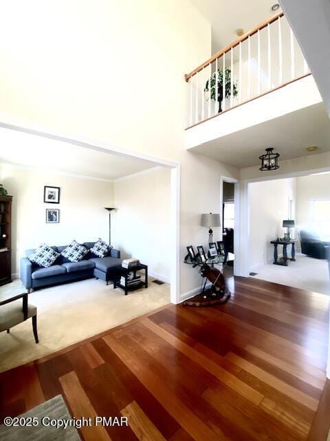 living room featuring a high ceiling and hardwood / wood-style floors