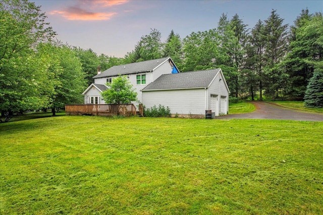 188 Cress Dr, Saylorsburg, PA 18353 - view of side of property featuring an attached garage, asphalt driveway, a lawn, and a wooden deck