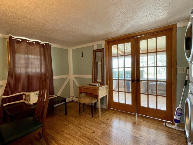 215 Outer Dr, Dingmans Ferry, PA 18328 - doorway featuring french doors, stacked washer / drying machine, and wood finished floors