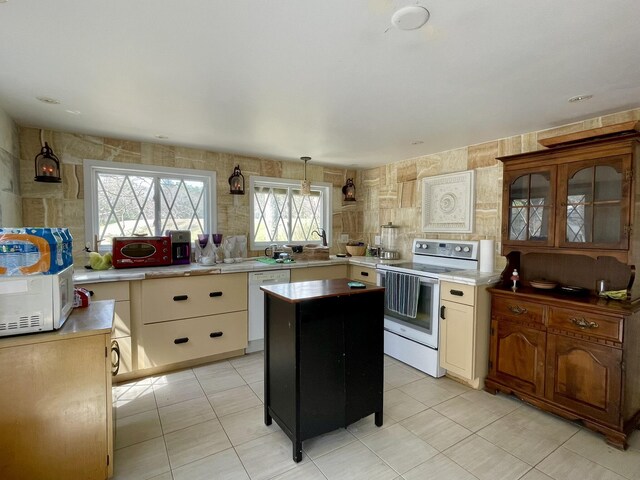215 Outer Dr, Dingmans Ferry, PA 18328 - kitchen featuring a center island, light countertops, white appliances, and light tile patterned flooring