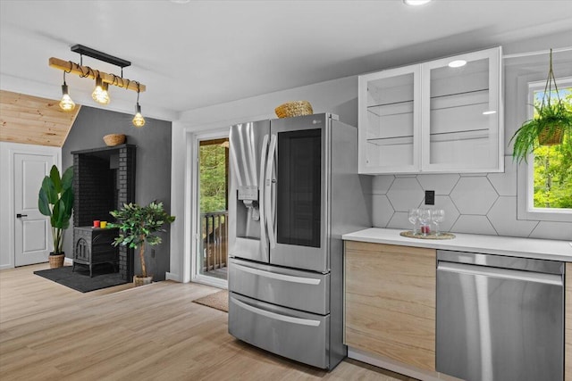 483 Alter Ave, Pocono Summit, PA 18346 - kitchen featuring stainless steel appliances, light countertops, decorative backsplash, light wood-style floors, and glass insert cabinets