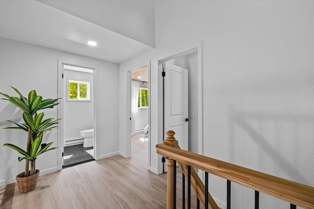 483 Alter Ave, Pocono Summit, PA 18346 - hallway featuring light wood-style floors, a baseboard heating unit, baseboards, an upstairs landing, and recessed lighting