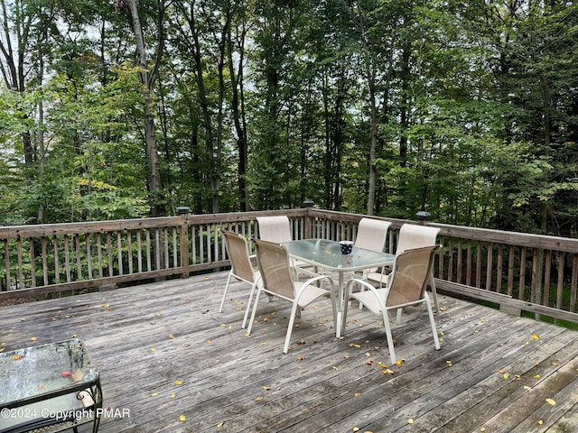 wooden terrace with outdoor dining space