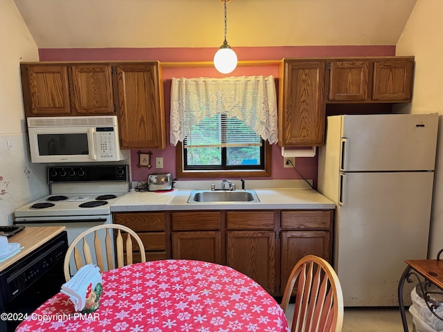 kitchen with white appliances, light countertops, a sink, and brown cabinetry